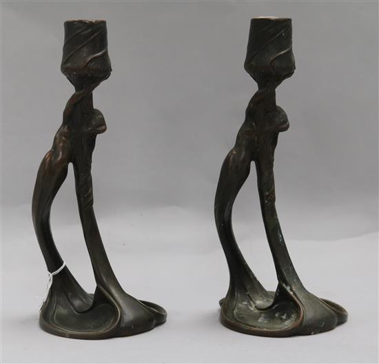 A pair of Secessionist bronze candlesticks